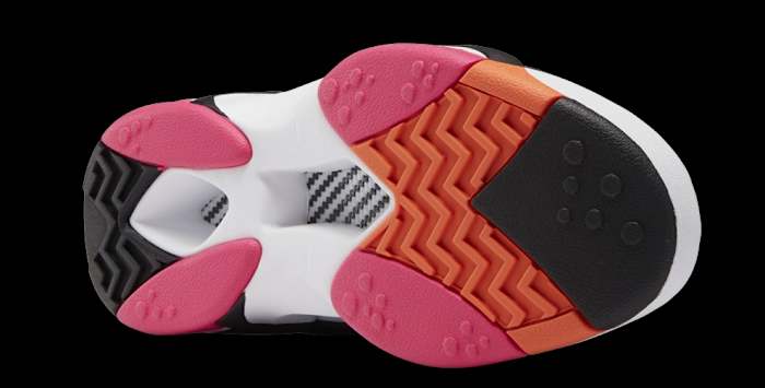 View of white, black, and orange Reebok sneaker outsole.
